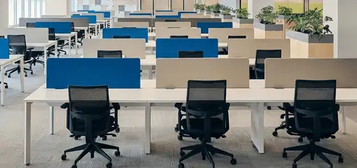 Modern open-plan office space featuring clean workstations, ergonomic chairs, and sanitized carpets provided by professional office cleaning services in Fargo, ND.