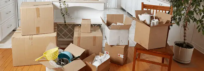 Packed moving boxes and household items in a kitchen before move-out or move-in cleaning, Fargo, ND.